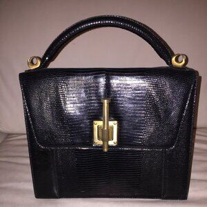 Donna Karen genuine black lizard handbag with satin gold closure.